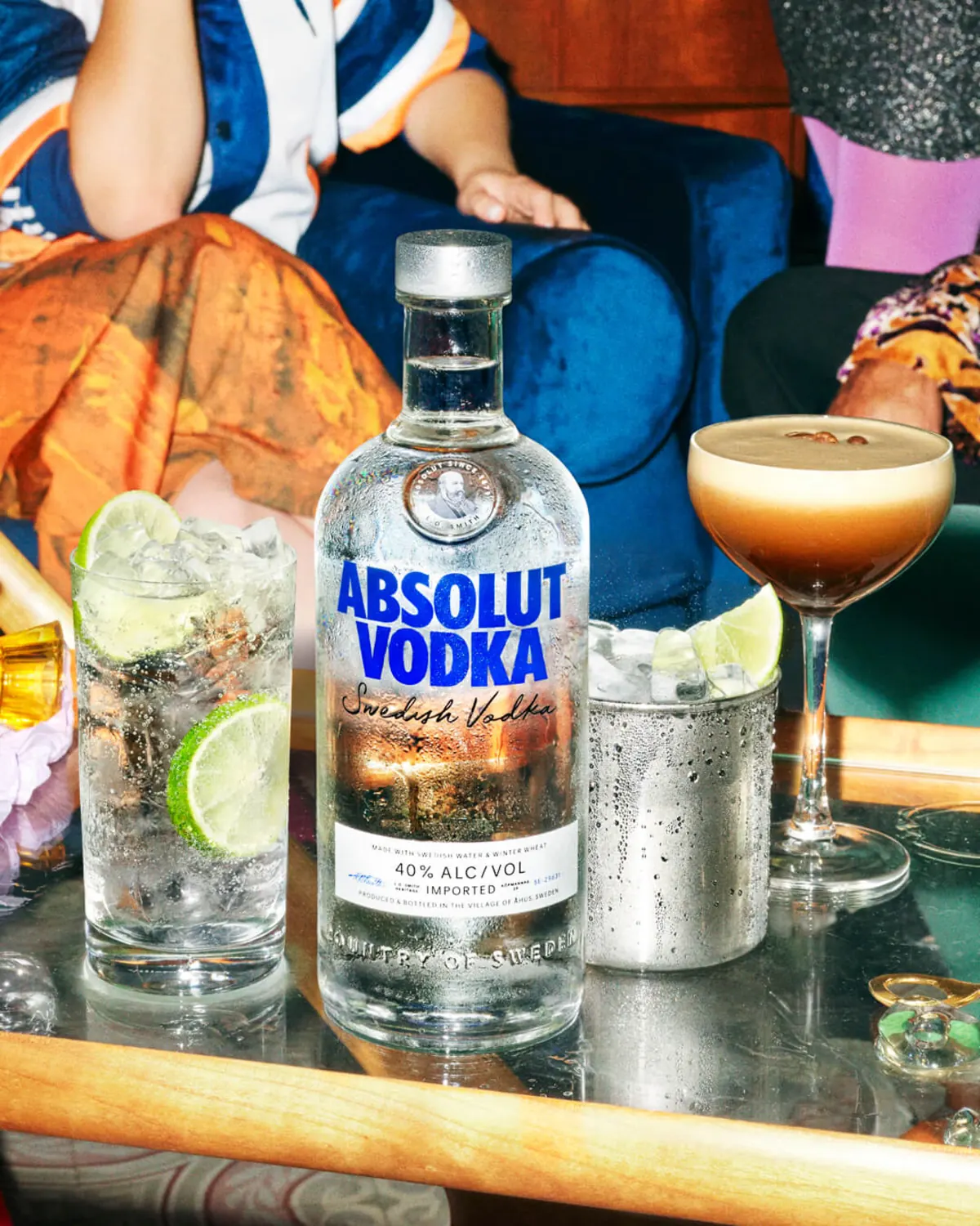 Absolut Vodka bottle surrounded by colourful cocktails