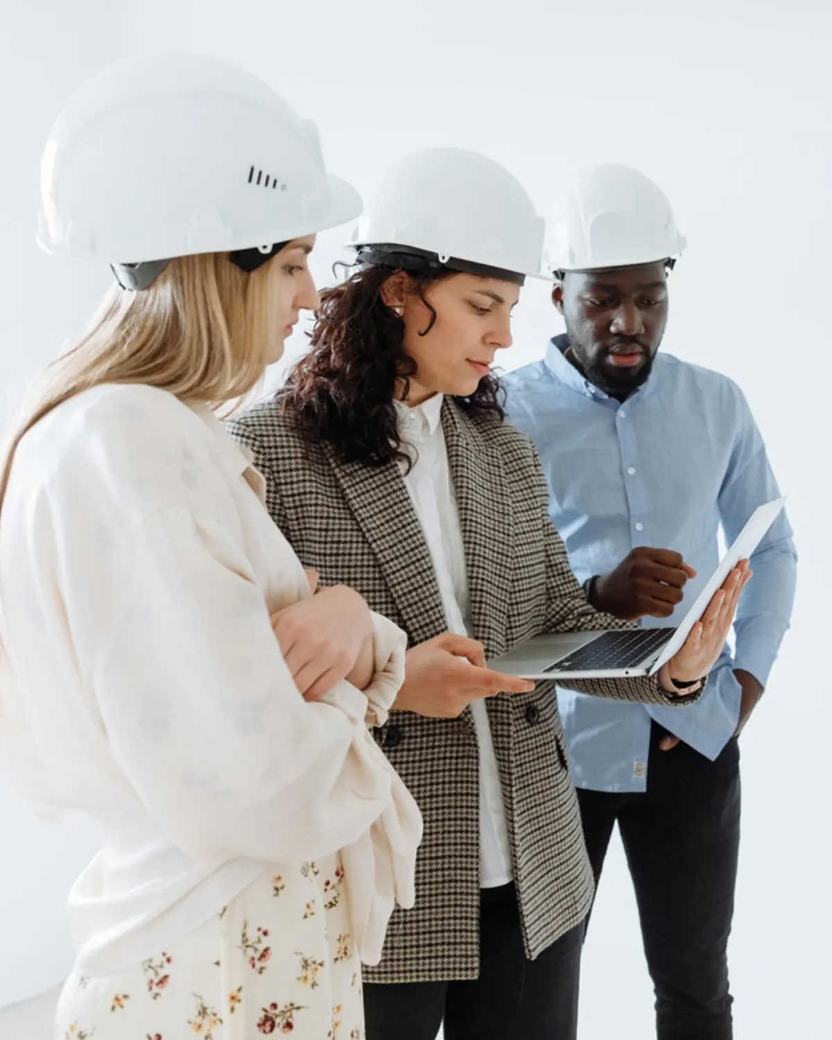 Construction team reviewing project plans on a laptop
