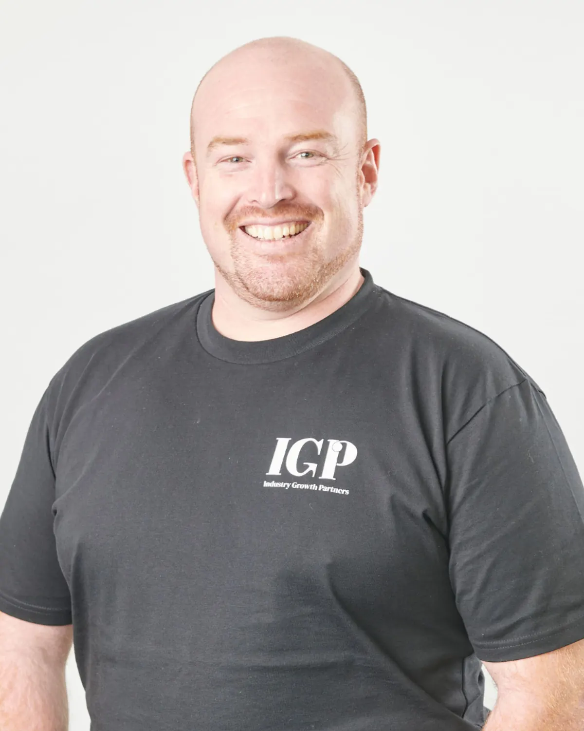 Ryan Marra smiling in an Industry Growth Partners T-shirt