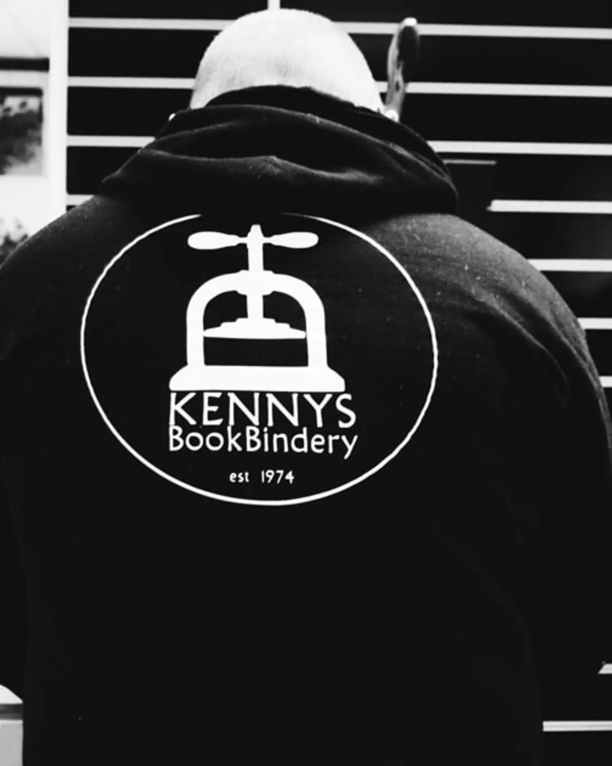 Kenny's BookBindery craftsperson wearing a branded hoodie