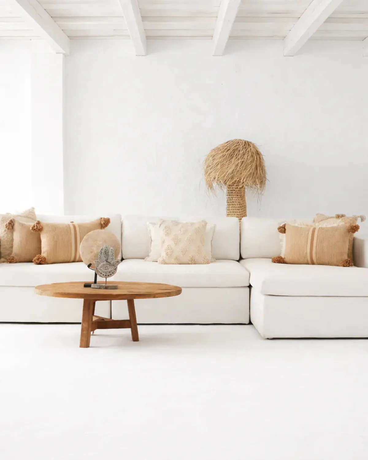 White modular sofa with neutral cushions and wooden coffee table